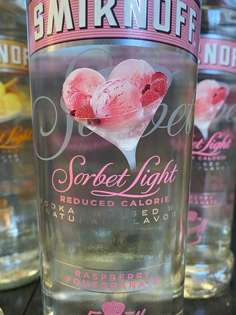 A close up of a bottle of smirnoff sorbet light vodka