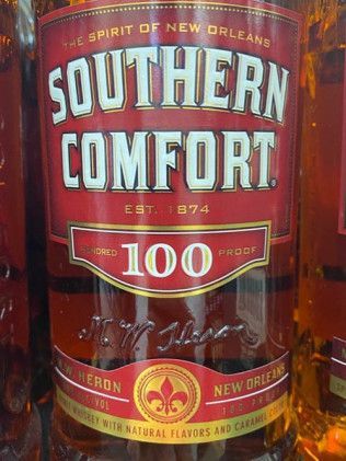 A close up of a bottle of southern comfort 100
