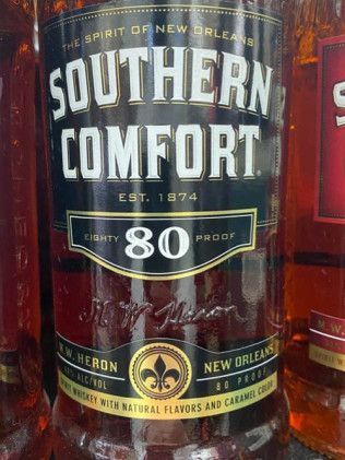 A close up of a bottle of southern comfort whiskey