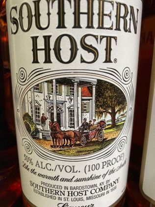 A bottle of southern host whiskey with a horse drawn carriage on the label.