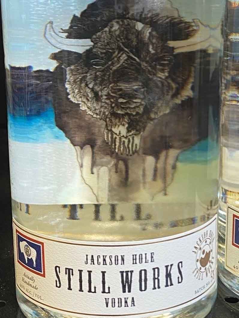 A bottle of still works vodka with a picture of a bison on the label.