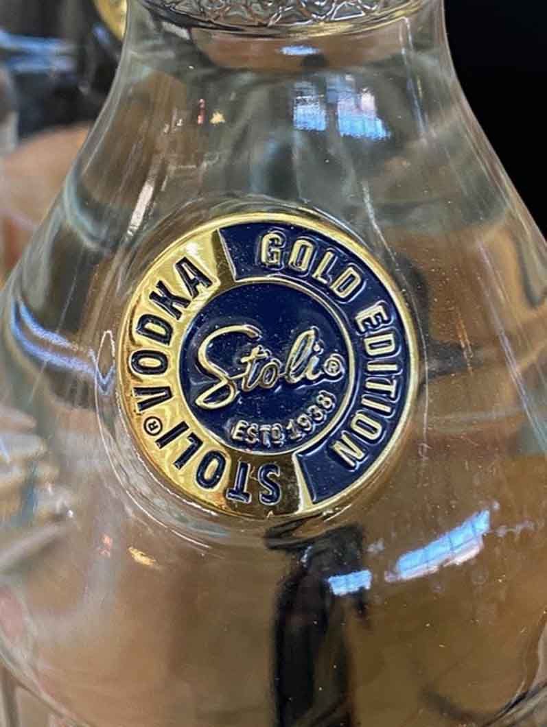 A close up of a bottle of gold edition vodka on a table.