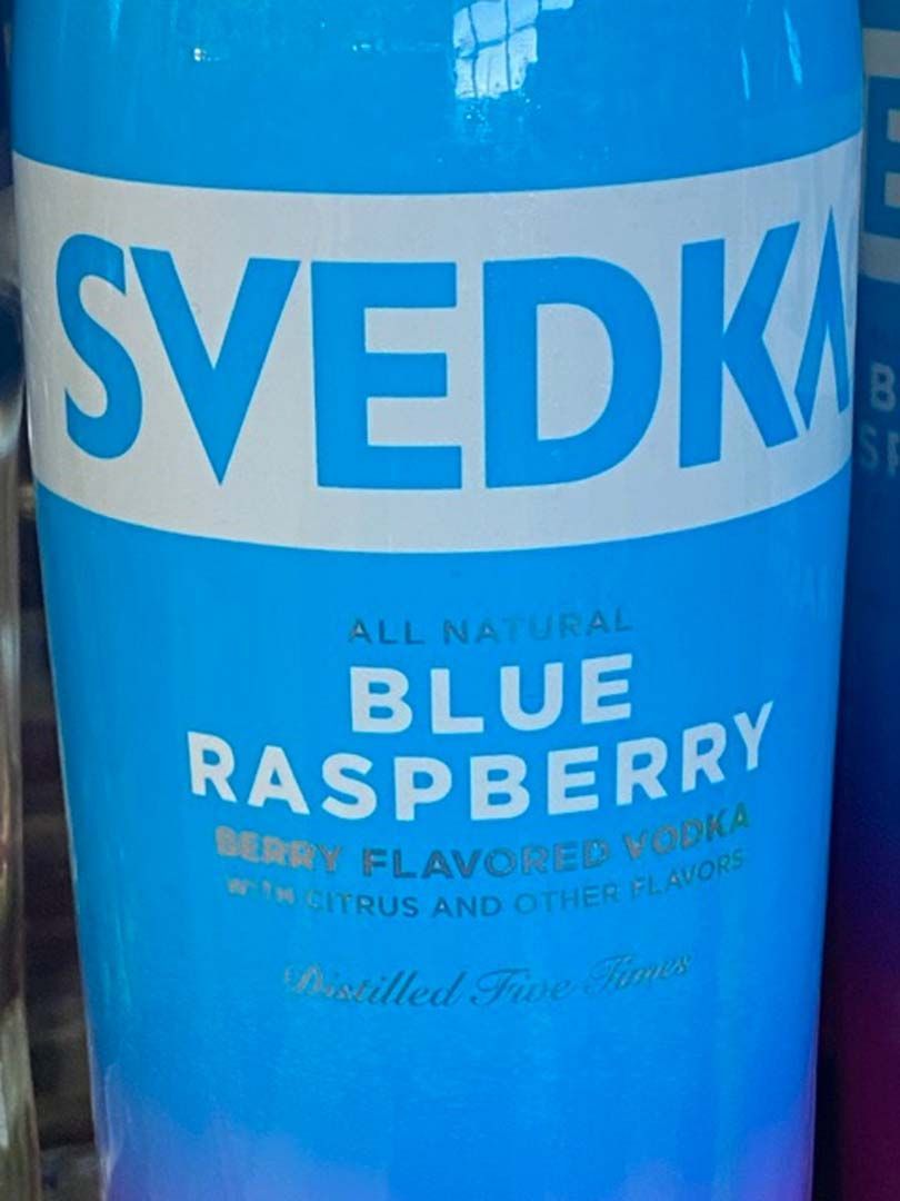 A blue bottle of svedka blue raspberry vodka