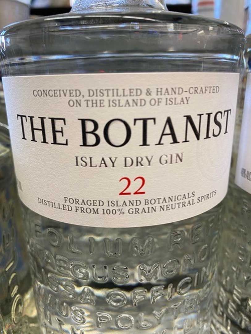 A bottle of the botanist islay dry gin is sitting on a table.