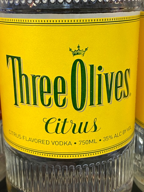 A bottle of three olives citrus flavored vodka