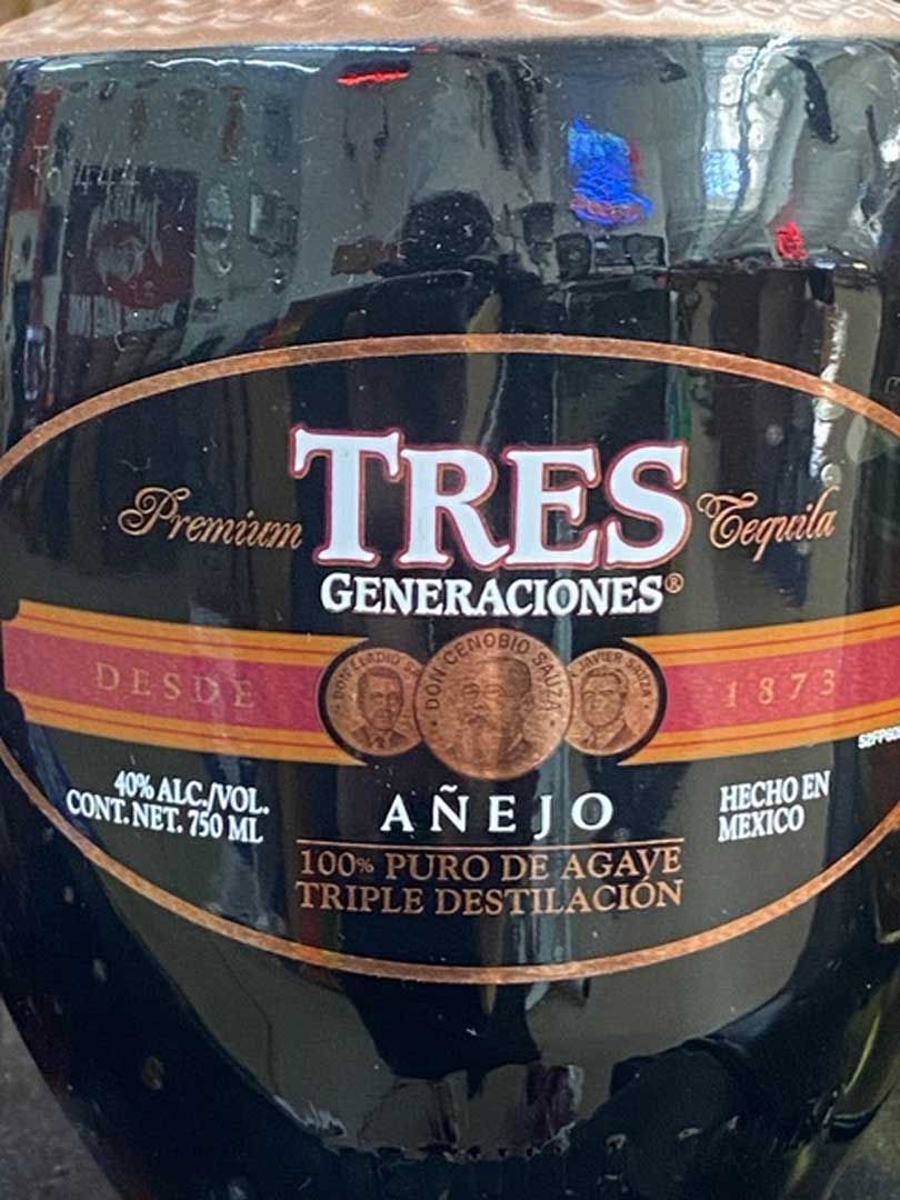 A close up of a bottle of tres generaciones anejo tequila