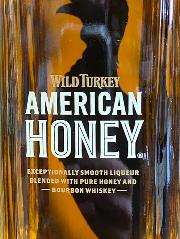 A bottle of wild turkey american honey bourbon whiskey
