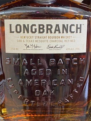 A bottle of longbranch small batch aged in american oak bourbon whiskey.