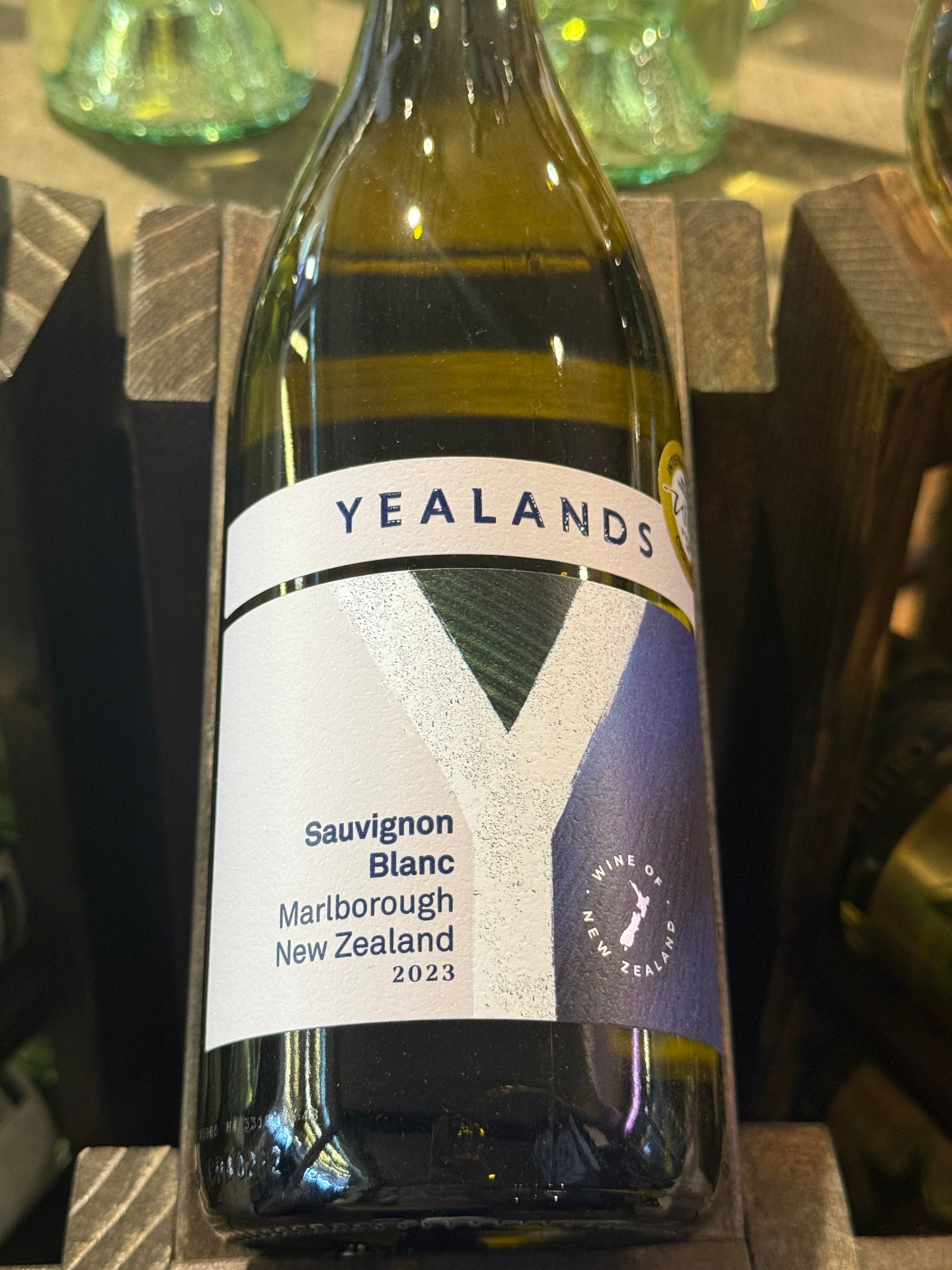 Bottle of Yealands Sauvignon Blanc from Marlborough, New Zealand, 2022, in wooden rack.