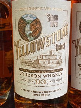 A bottle of yellowstone select bourbon whiskey is sitting on a table.