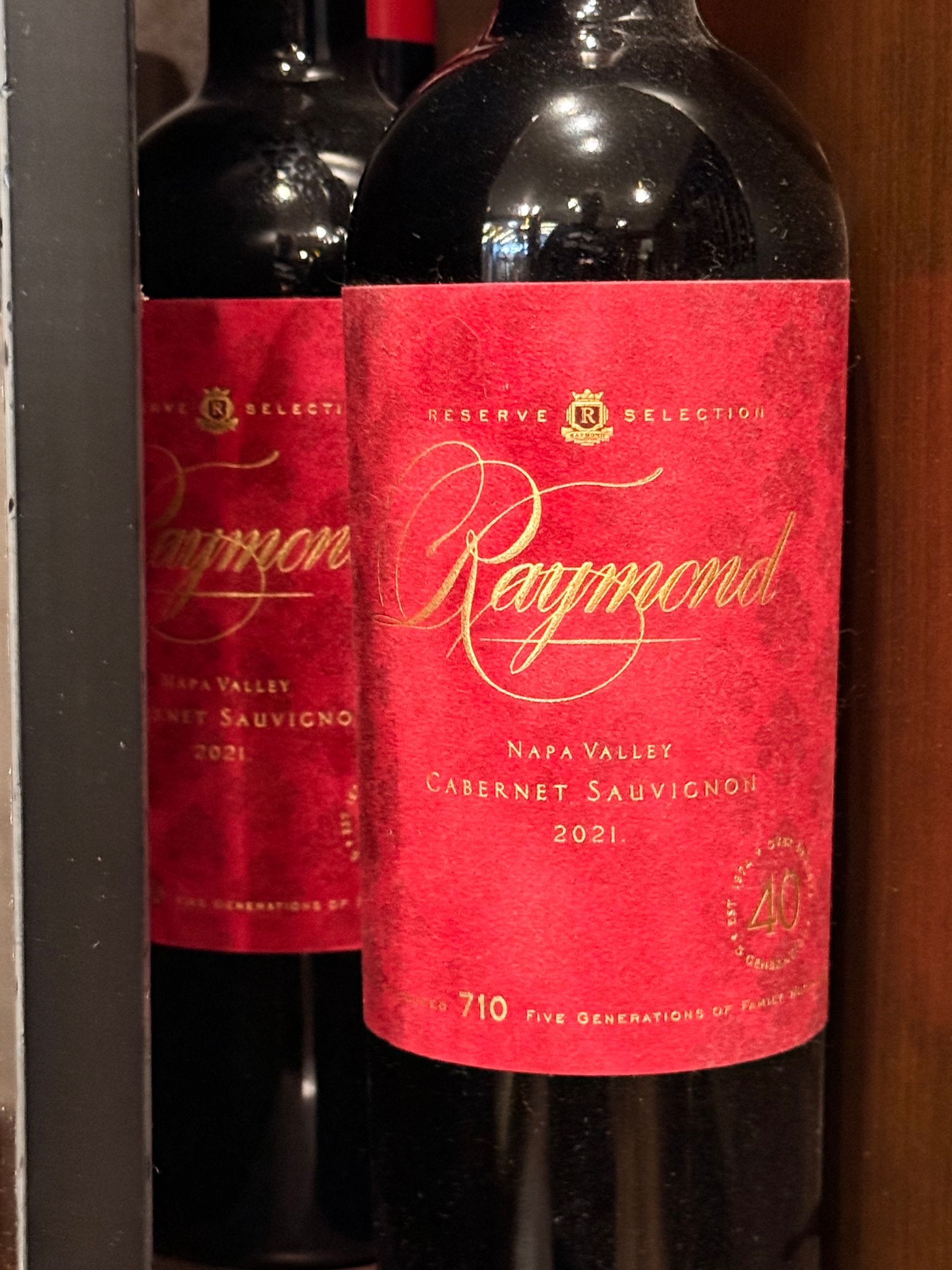 Bottle of Chateau Ste. Michelle wine in a wooden rack; label visible.