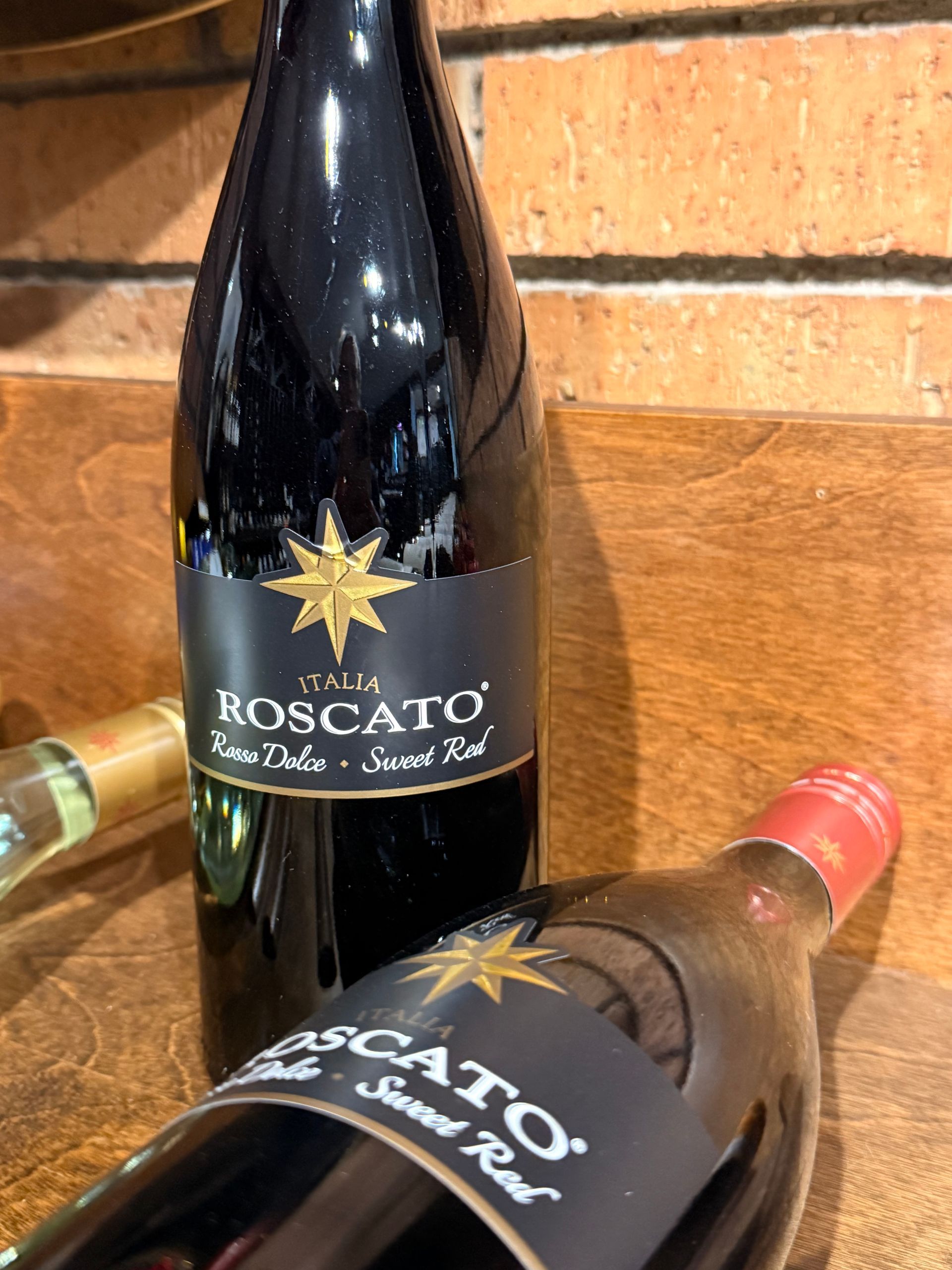 Francis Coppola Pinot Noir wine bottle with a blue label and a sign that reads 