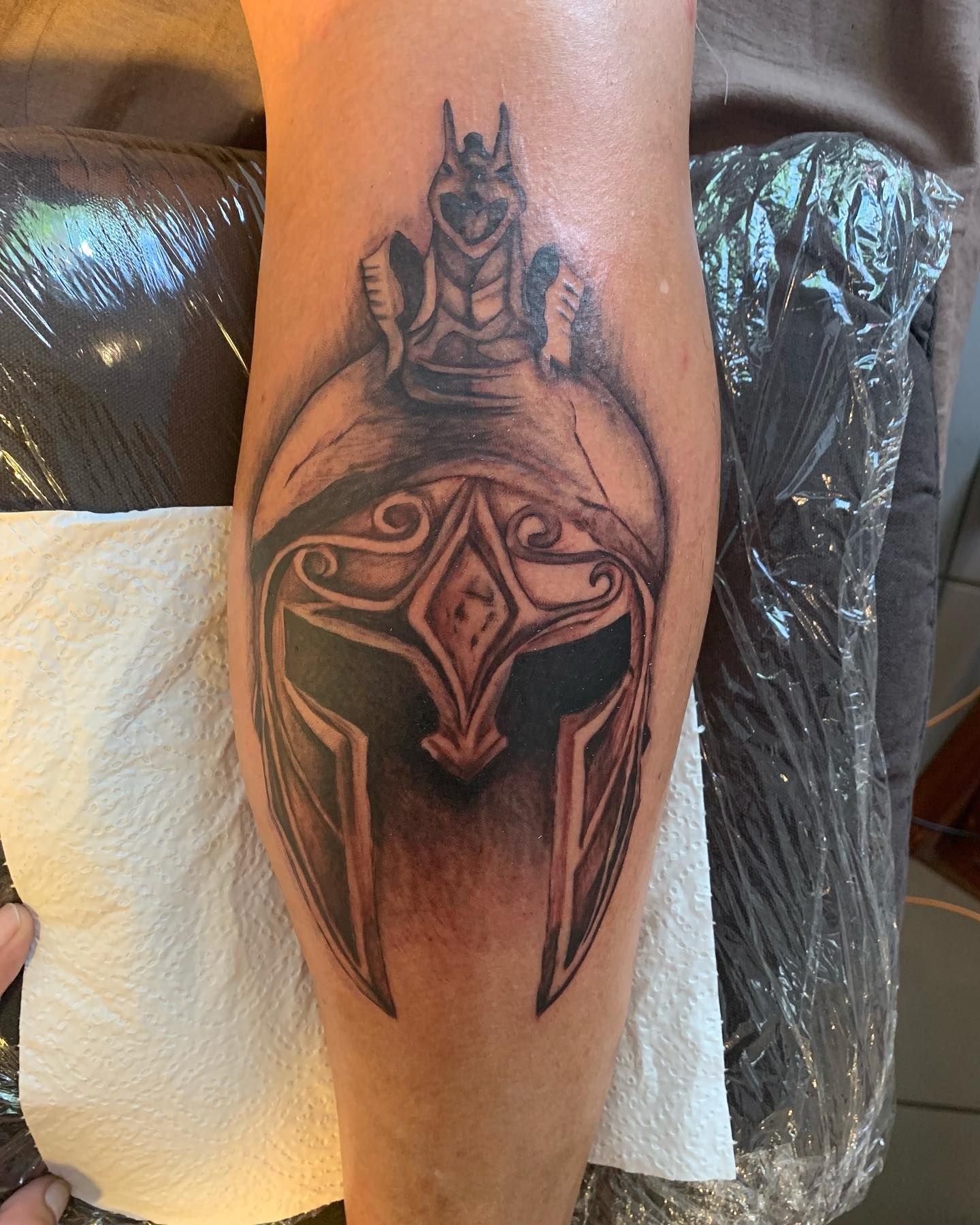 Tattoo of A Black and Gray Spartan Helmet on A Leg, with Detail Work — Thaiger Ink In Holloways Beach, QLD