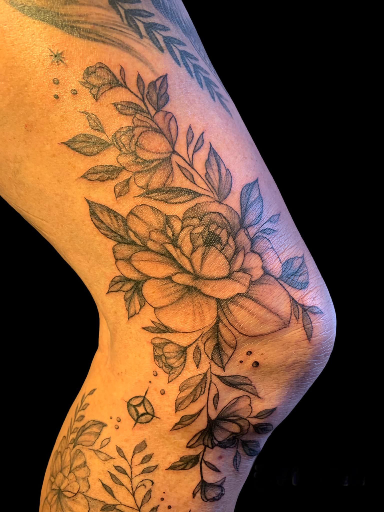 A Woman Has a Tattoo of Flowers and Leaves on Her Leg  — Thaiger Ink in Holloways Beach, QLD