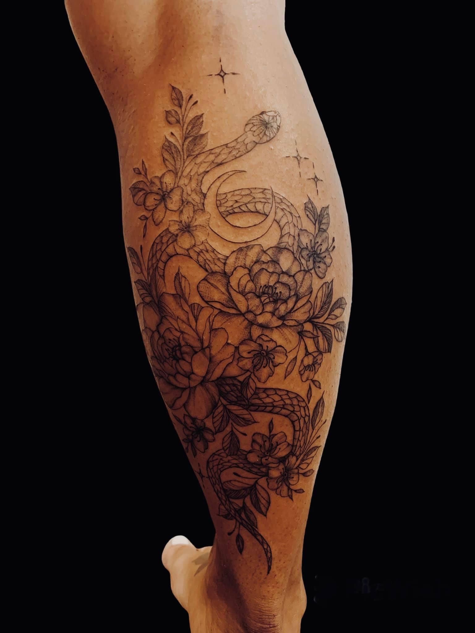 Leg Tattoo of A Snake Coiled Amidst Flowers and Crescent Moon — Thaiger Ink In Holloways Beach, QLD