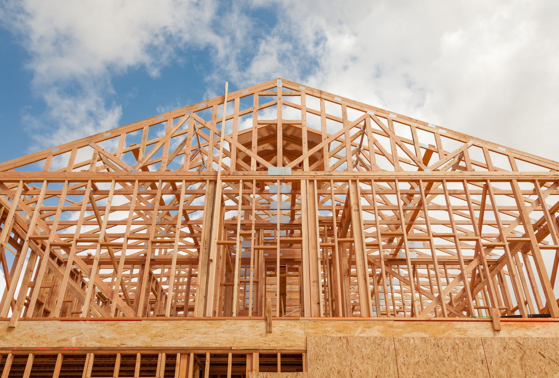 A house is being built with a blue sky in the background.