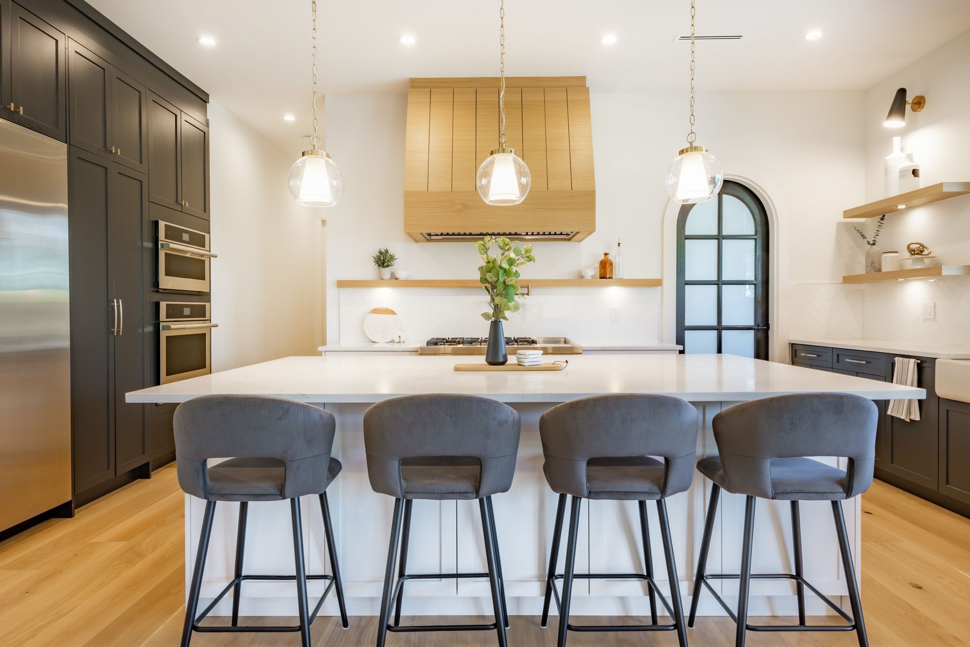 A kitchen with a large island and stools