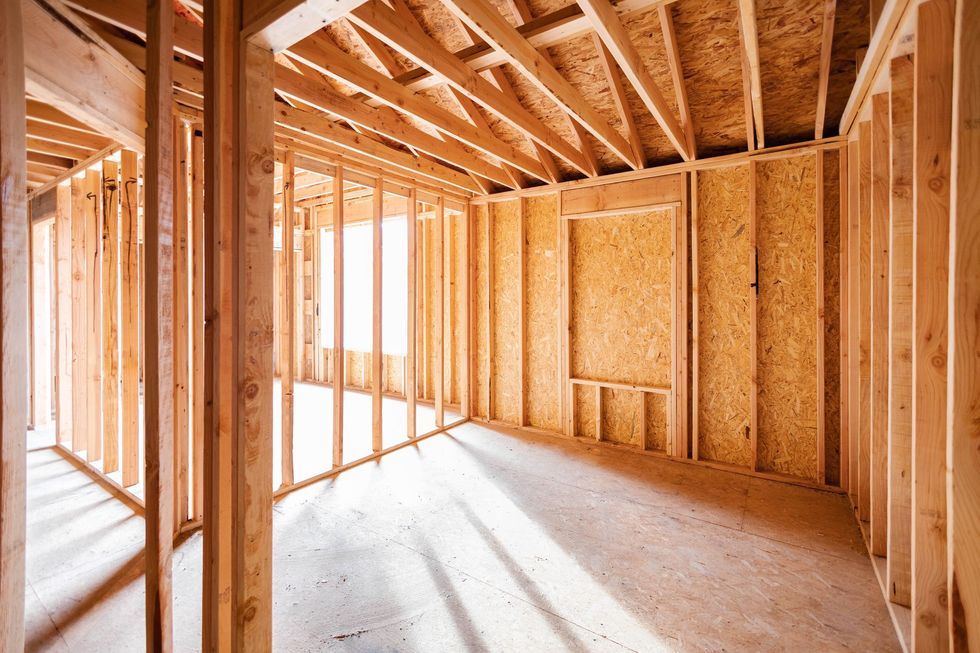 Interior of a building under construction, framed with wood studs.