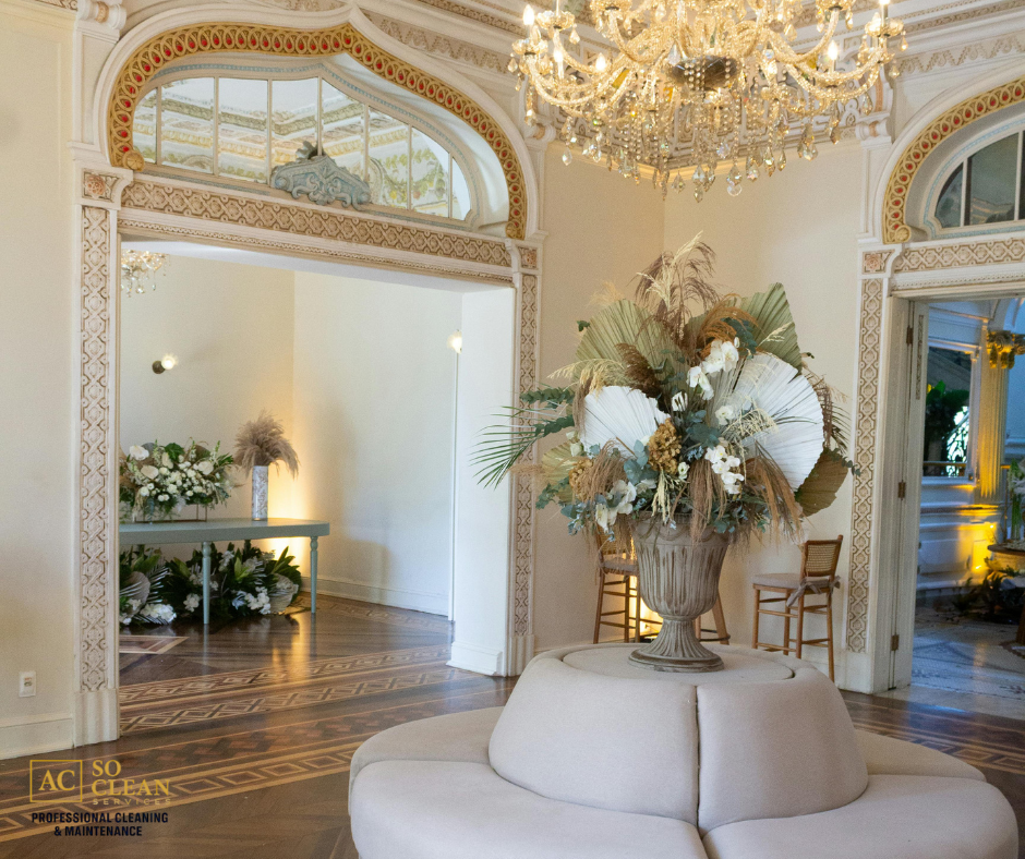 Close-up view of a janitorial worker using a mop to clean the restroom floor, with her cleaning trolley positioned nearby.