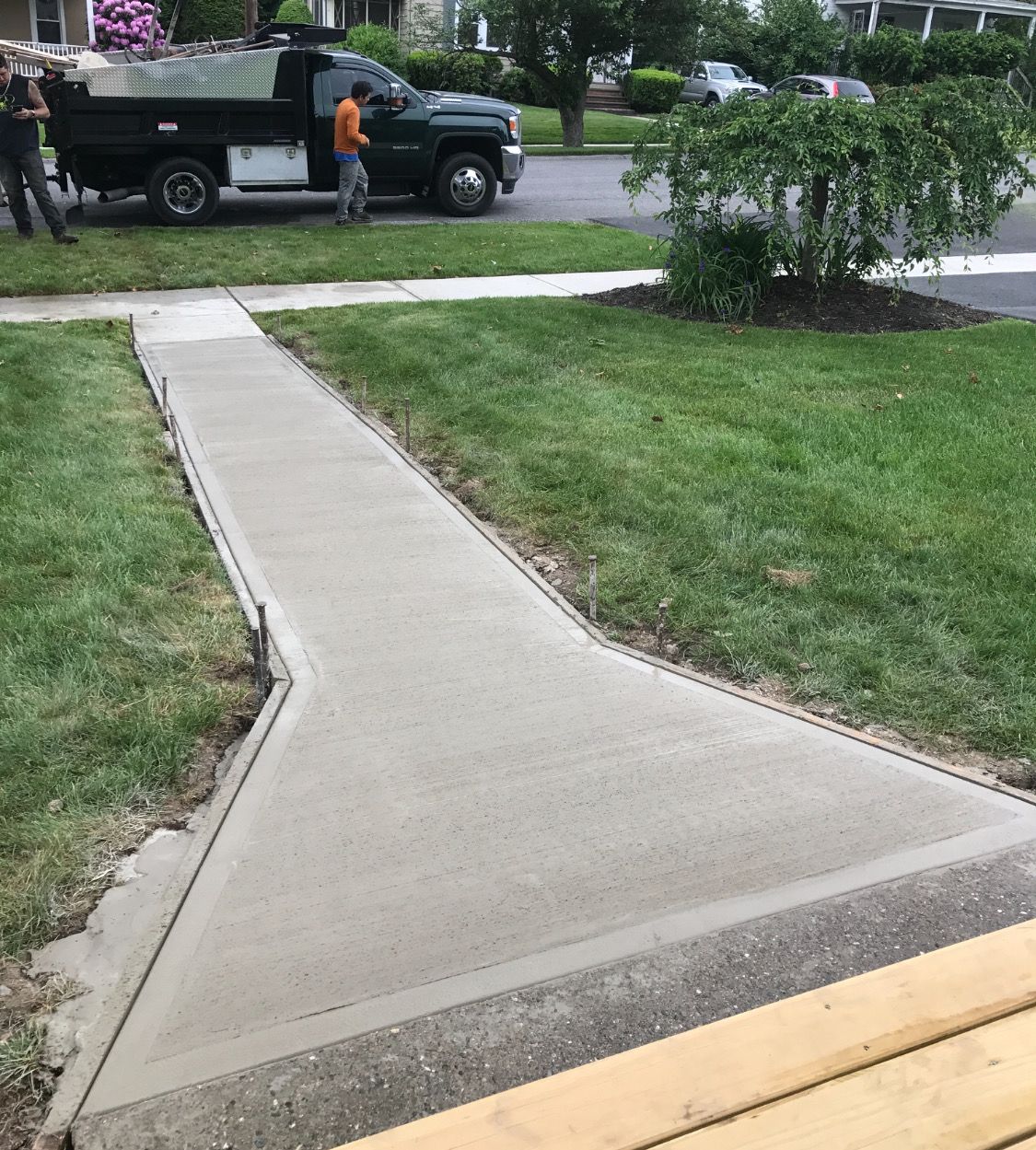 A concrete walkway with a truck parked on the side of it