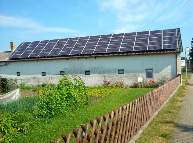 Ein Haus mit vielen Sonnenkollektoren auf dem Dach