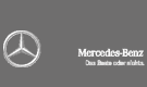 Ein Mercedes-Benz-Logo befindet sich auf einem grauen Hintergrund.