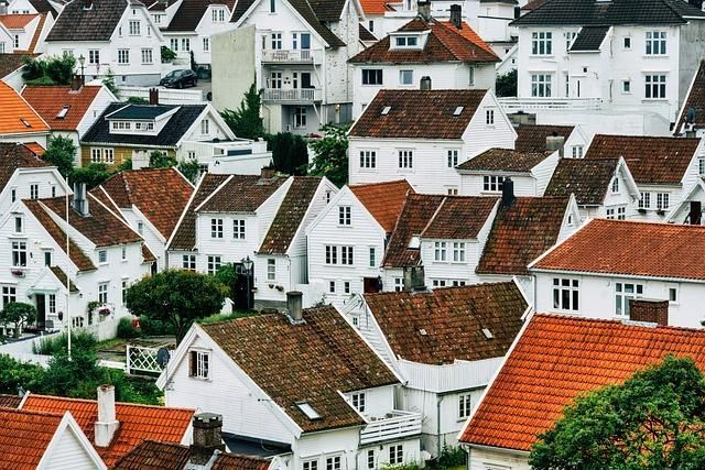 A Row of White Houses With Red Tile Roofs in a Small Town — Cutting Edge Painting Contractors QLD in Chatsworth, QLD