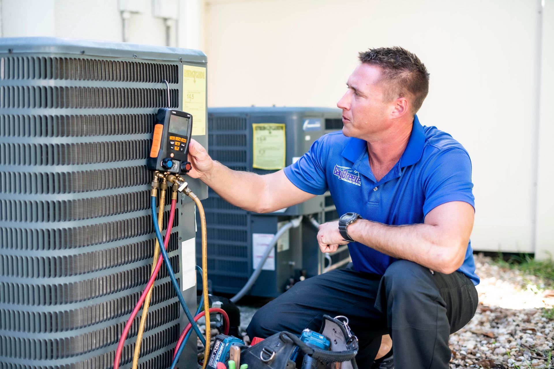 HVAC technician using a multimeter on an outdoor air conditioning unit