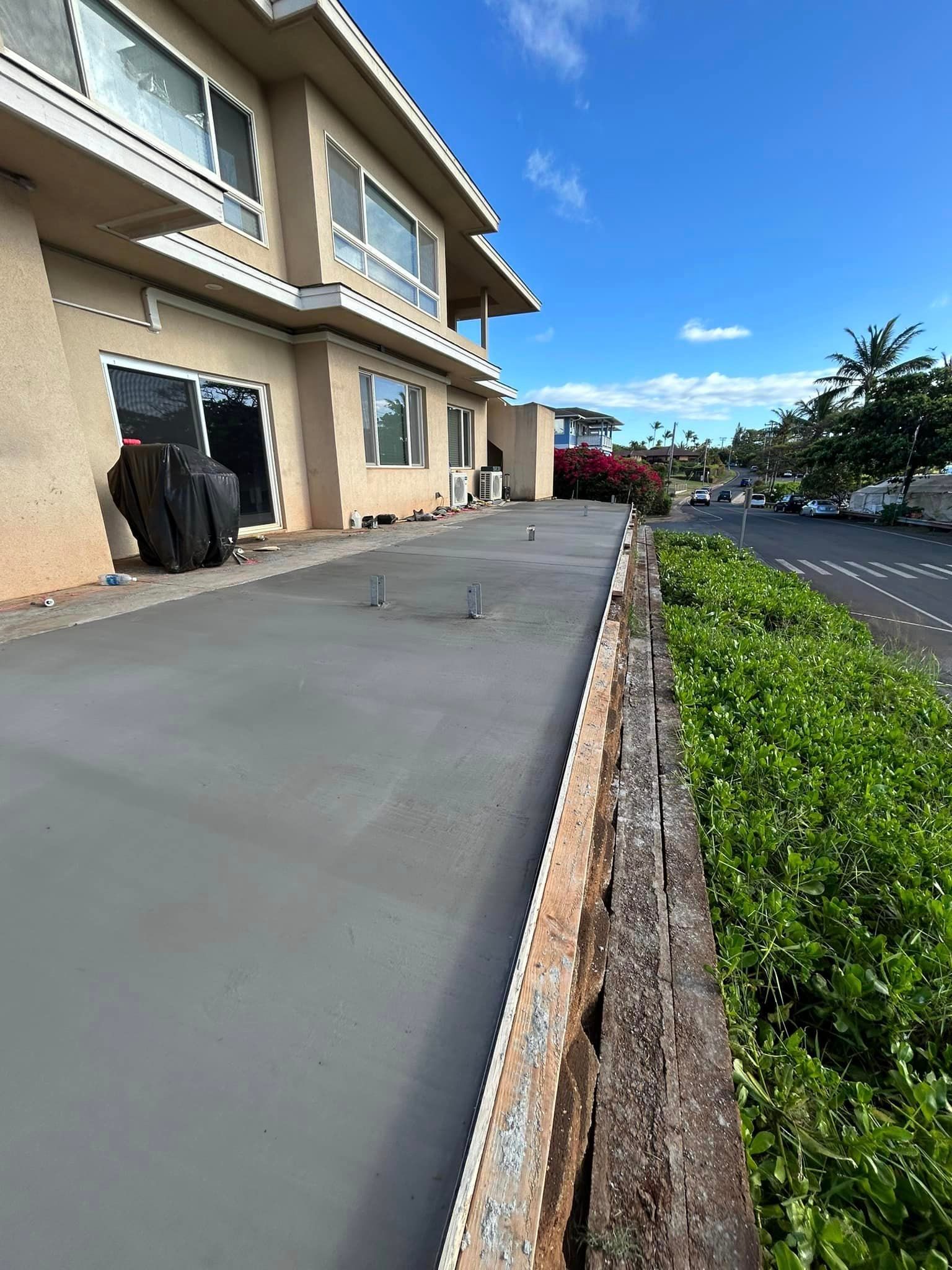 A large house with a concrete driveway in front of it.