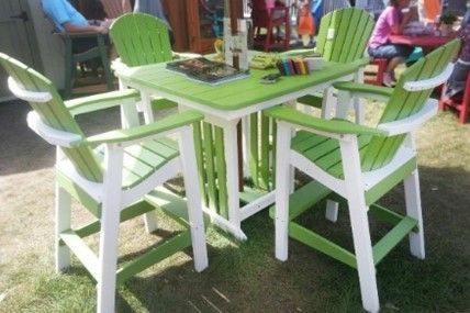 A green and white patio set with a table and chairs