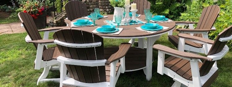 A table and chairs are sitting on top of a lush green lawn.