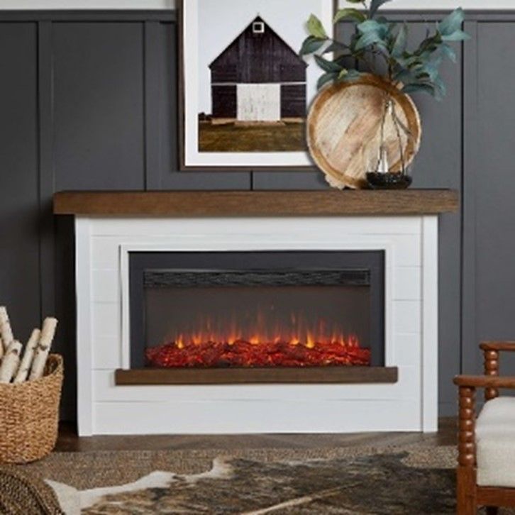 A fireplace with a picture of a barn above it
