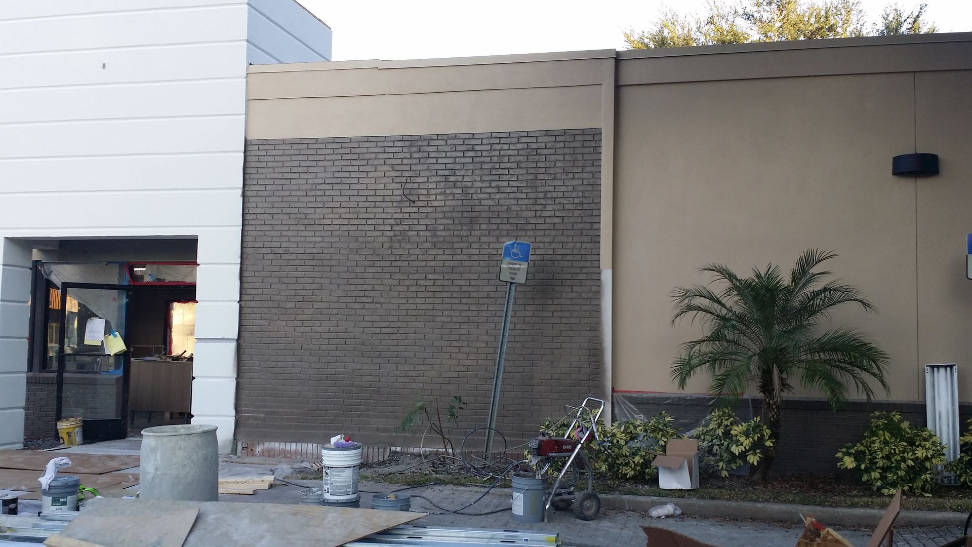 A building under construction with a vacuum cleaner in front of it
