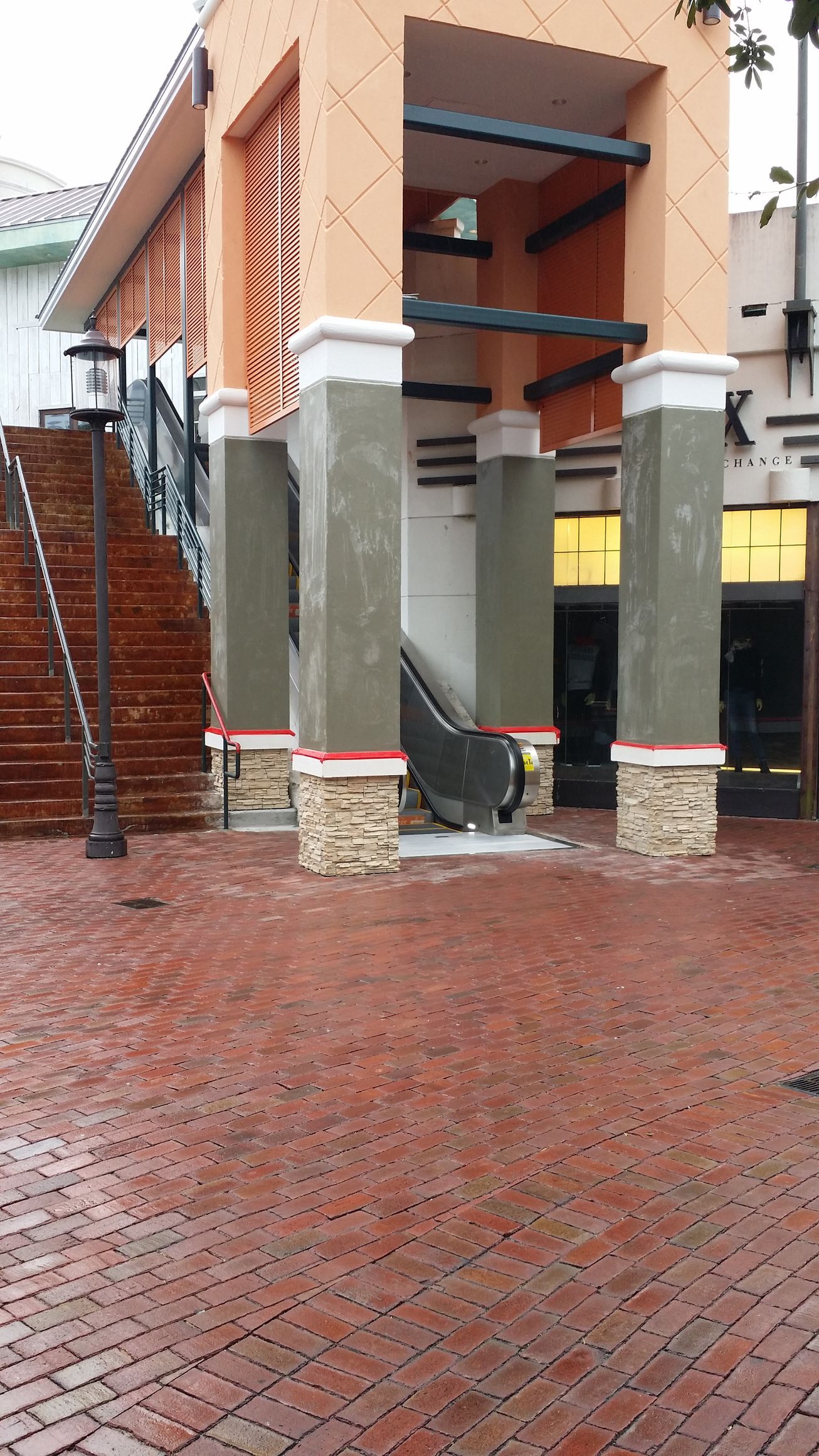 A building with stairs and an escalator in front of it