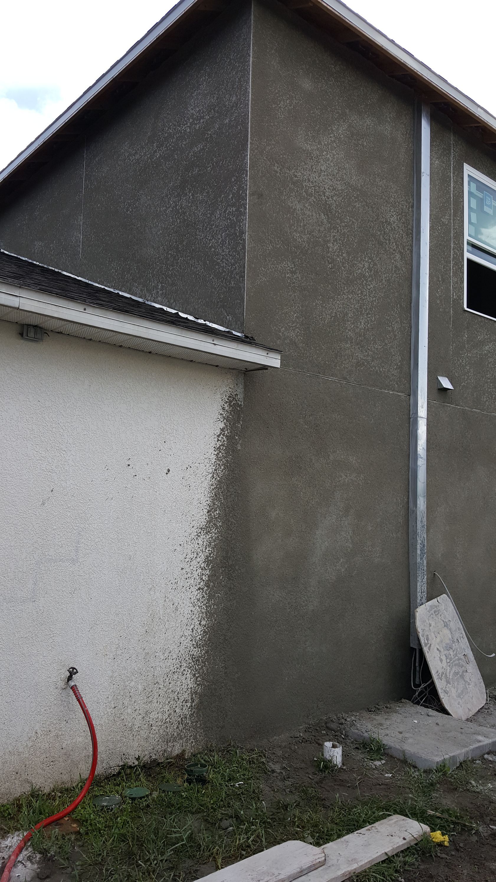 A house with a hose attached to the side of it.