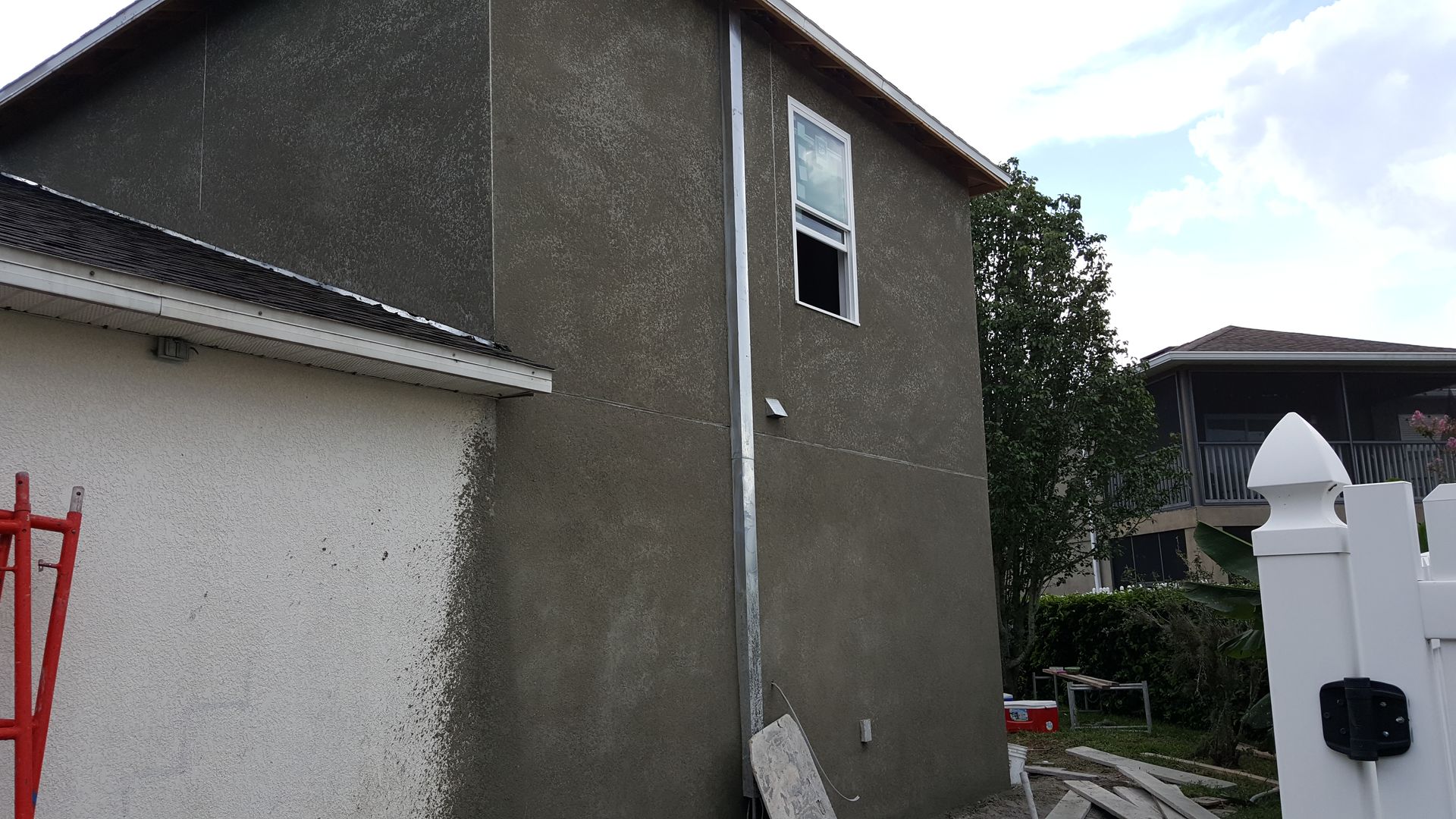 A house with a broken window is being remodeled