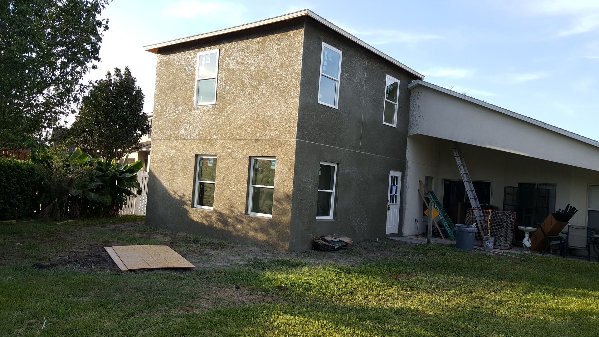 A house that is being built with a lot of windows