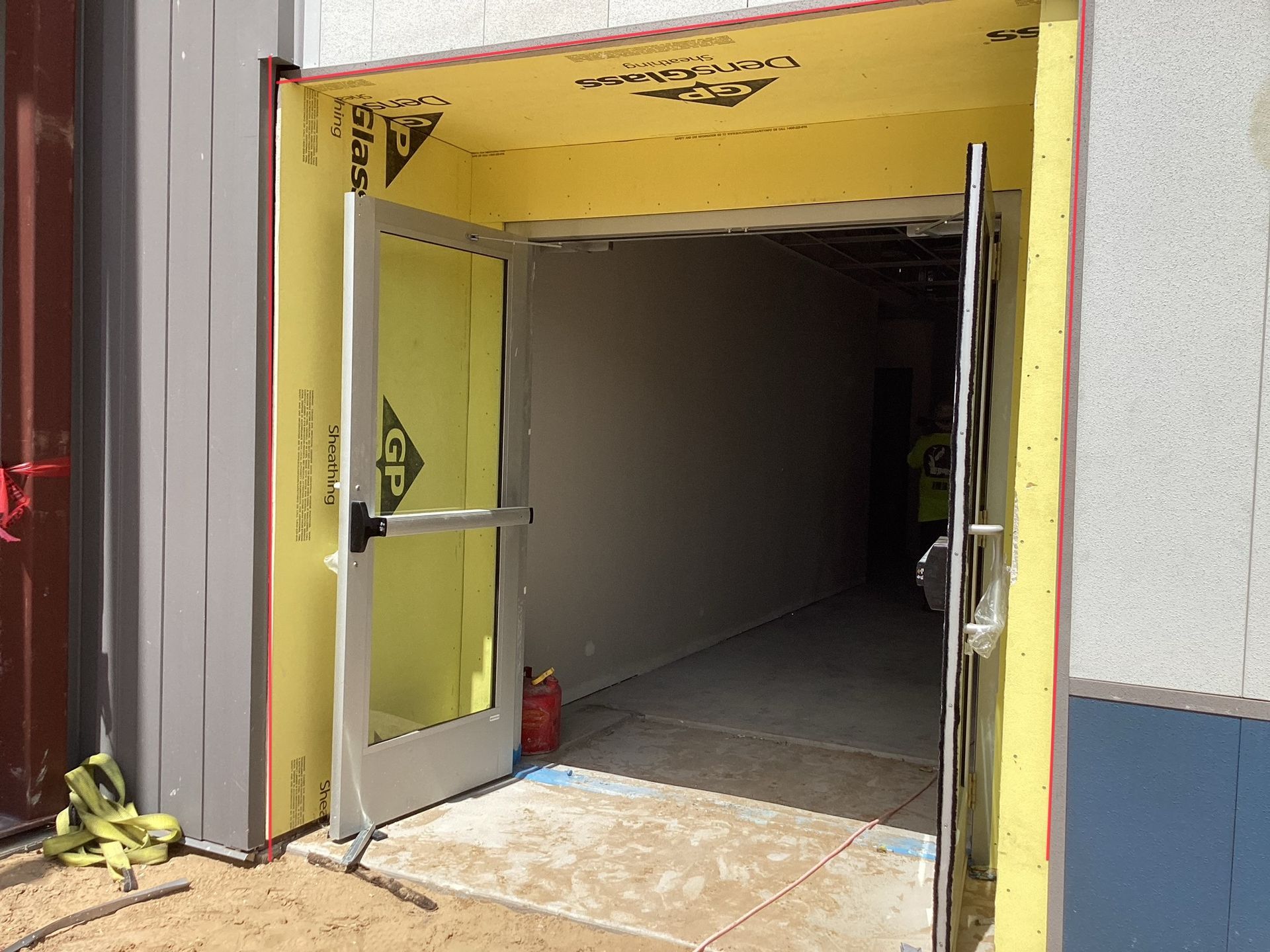 A door is open to a building under construction.