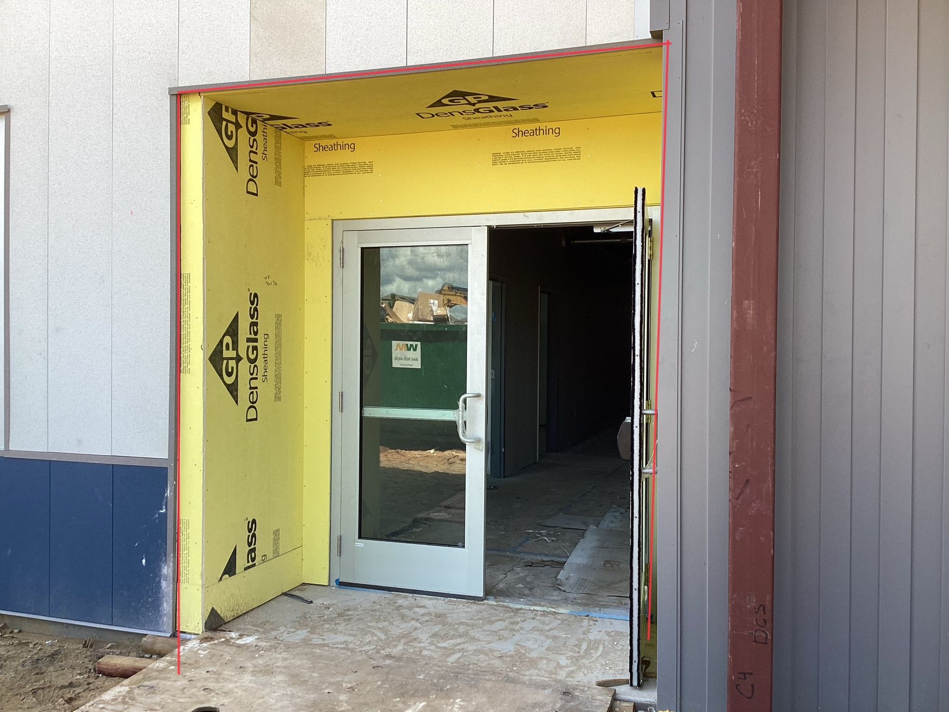 A building under construction with a door that is open