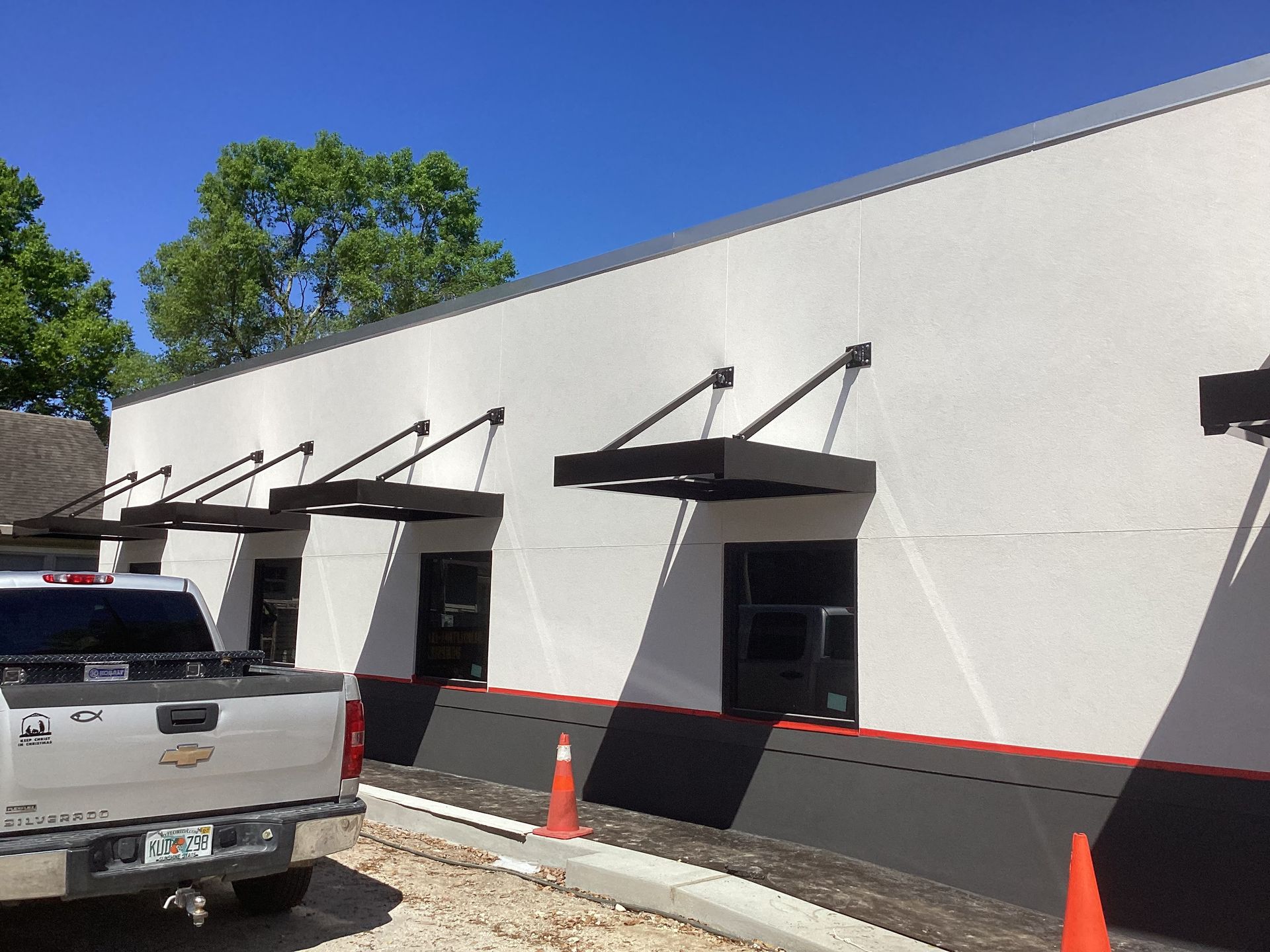 A truck is parked in front of a building that is under construction