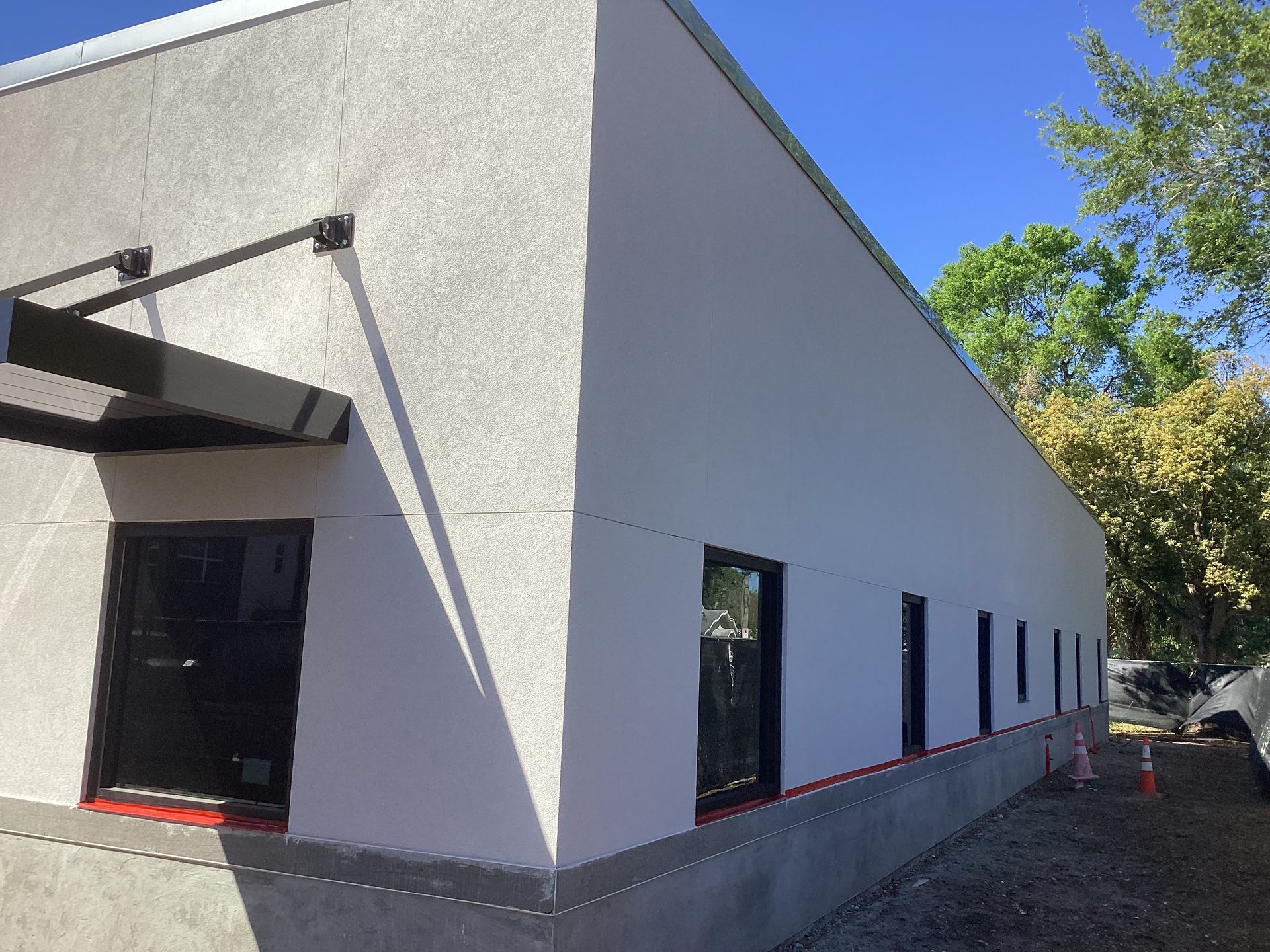 A white building with a canopy on the side of it