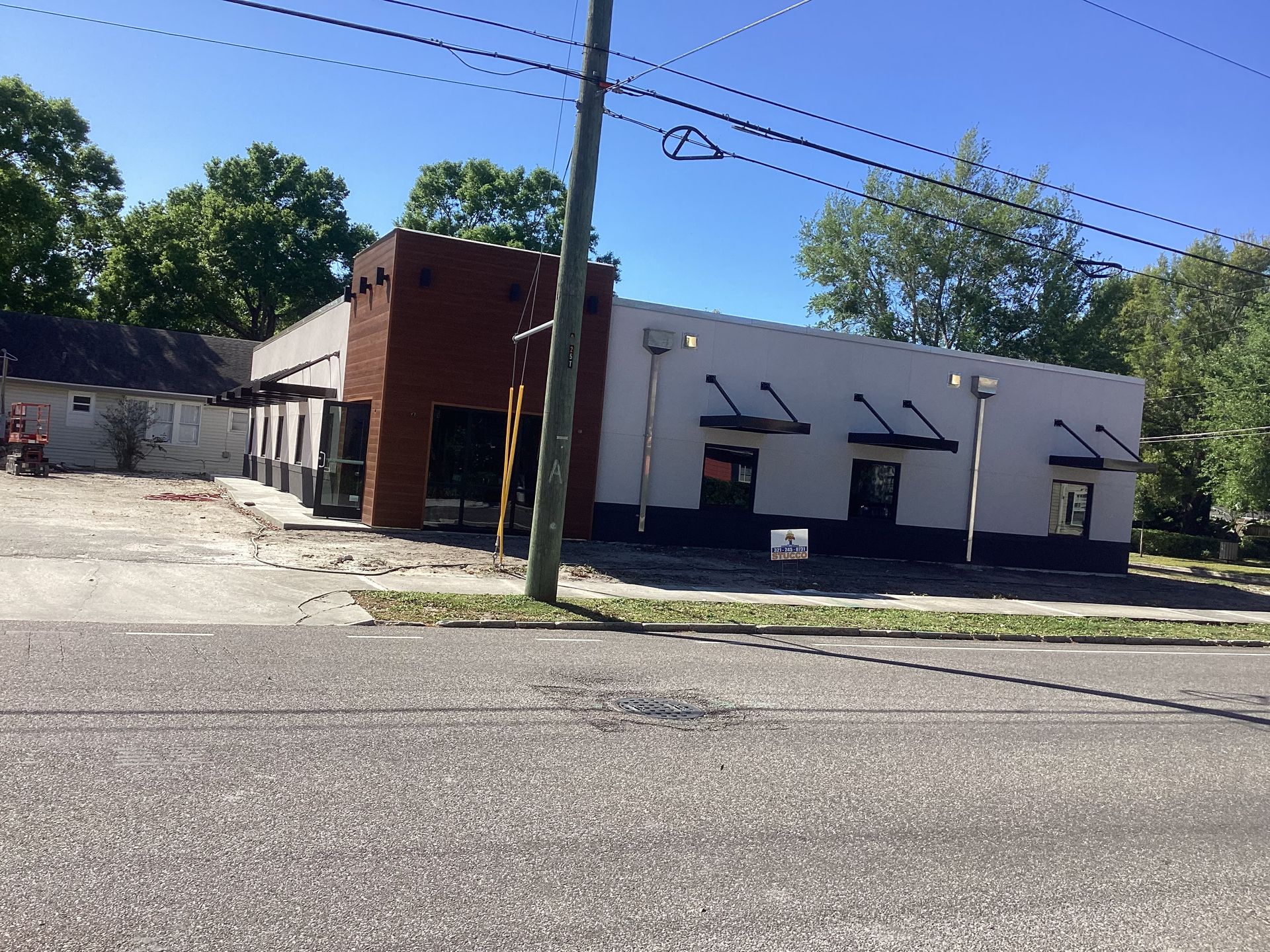 A building with a sign that says ' for sale ' on it