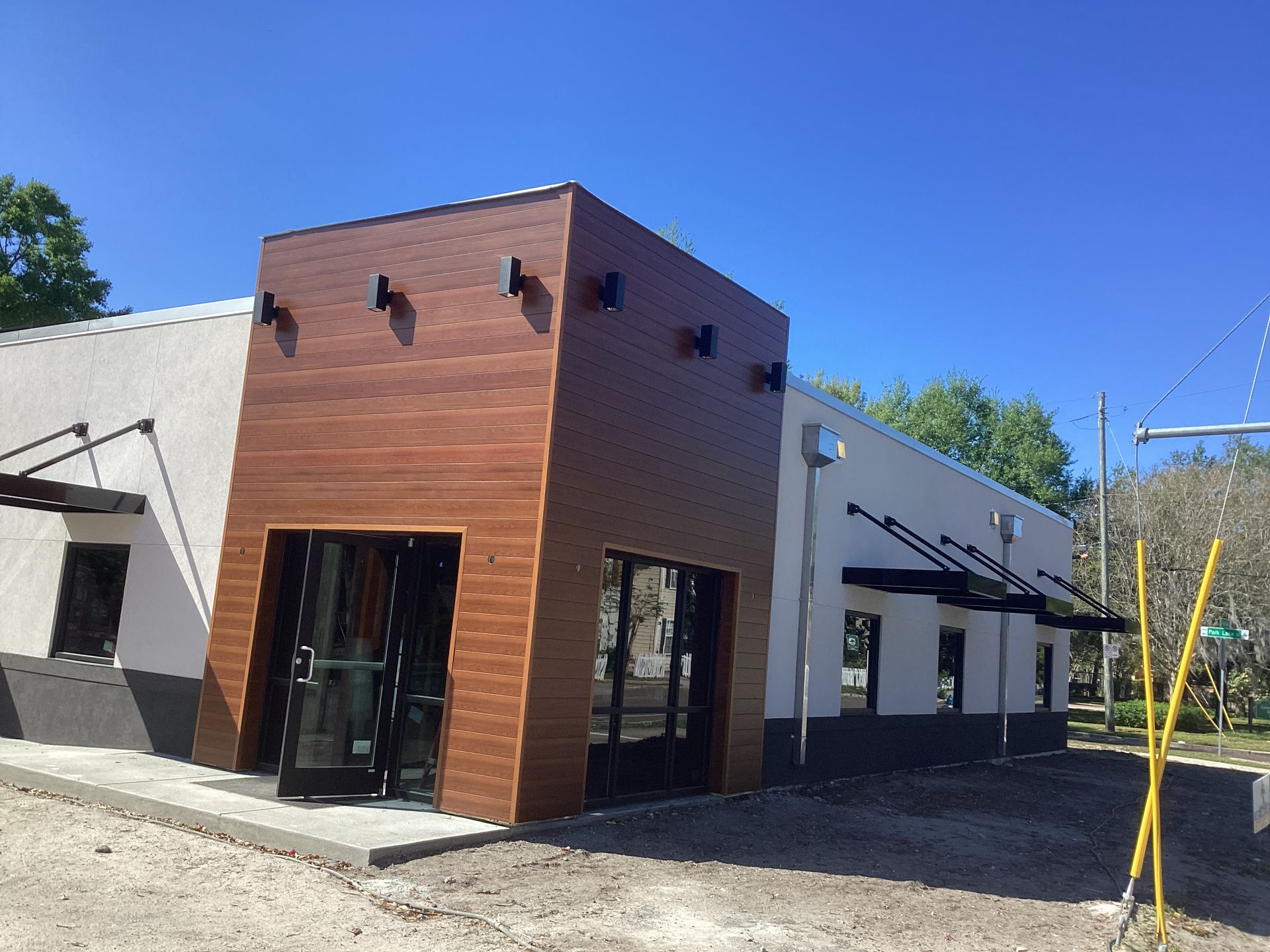 A white building with a wooden facade and a lot of windows