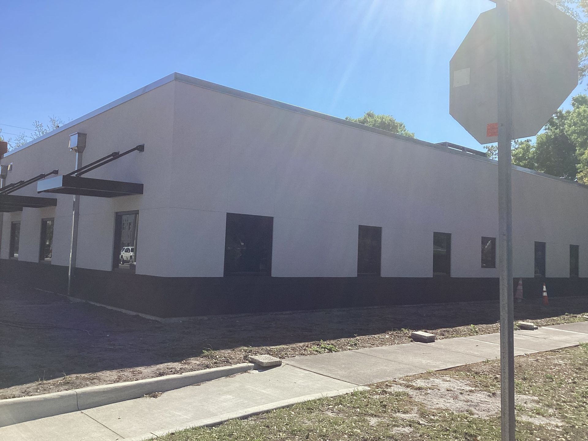 A large white building with a stop sign in front of it.
