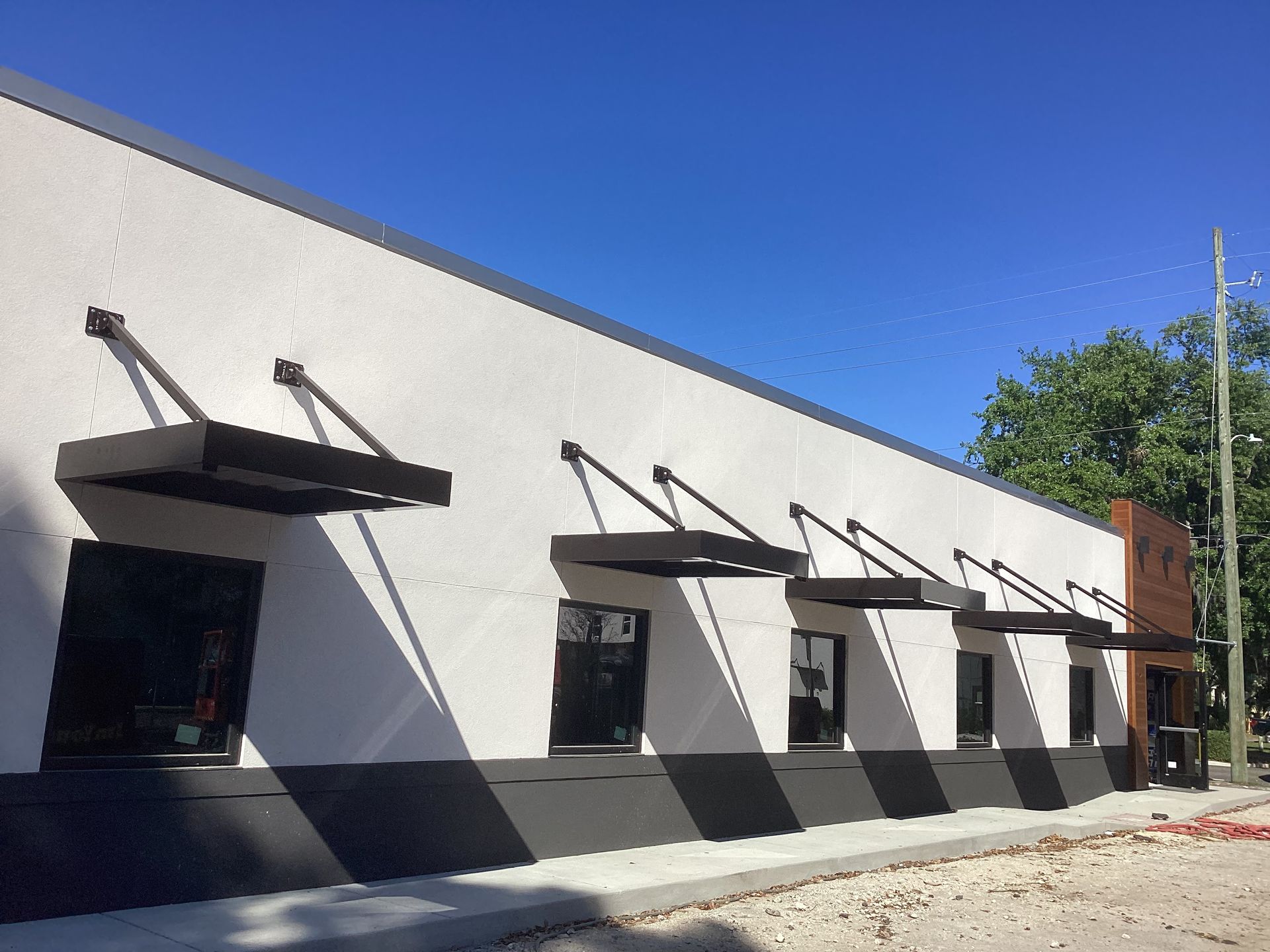 A building with a lot of windows and awnings on it