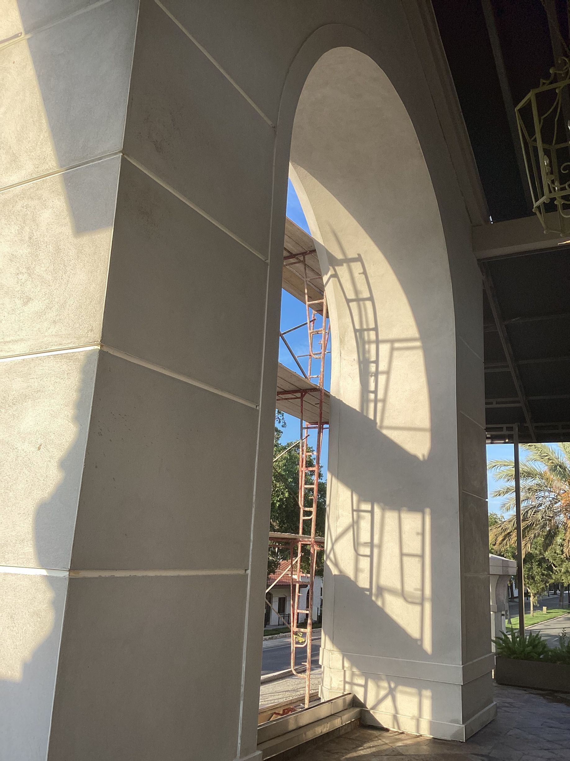 A large archway with a shadow on the wall