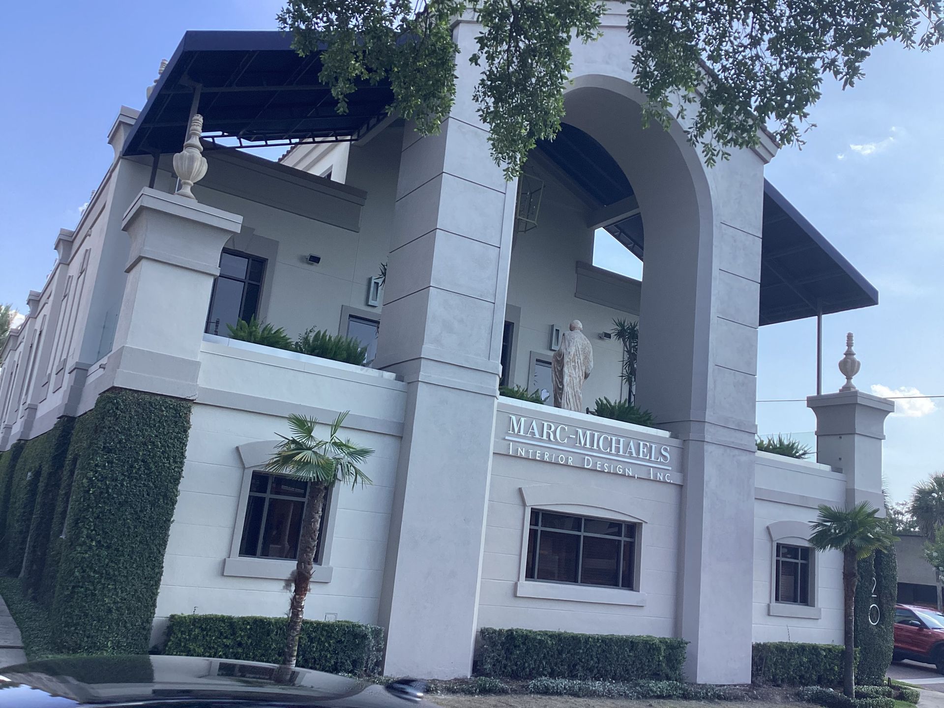 A large white building with a statue on top of it