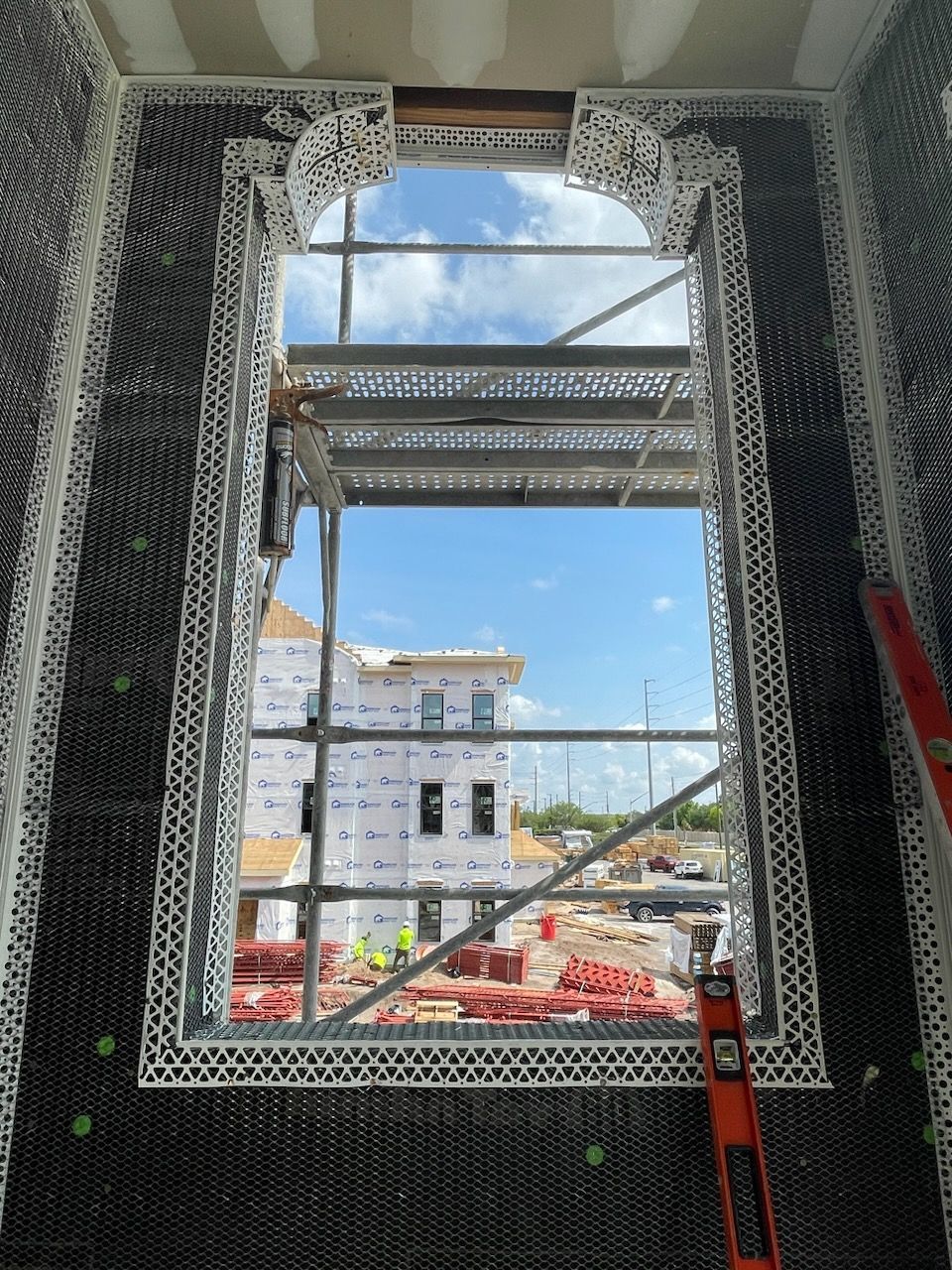 A window in a building under construction with scaffolding around it