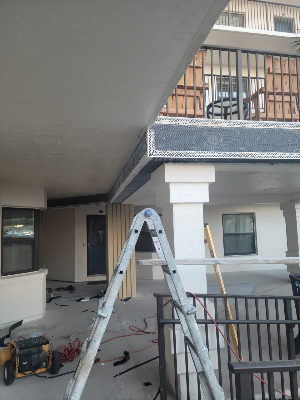 A ladder is sitting in front of a building under construction