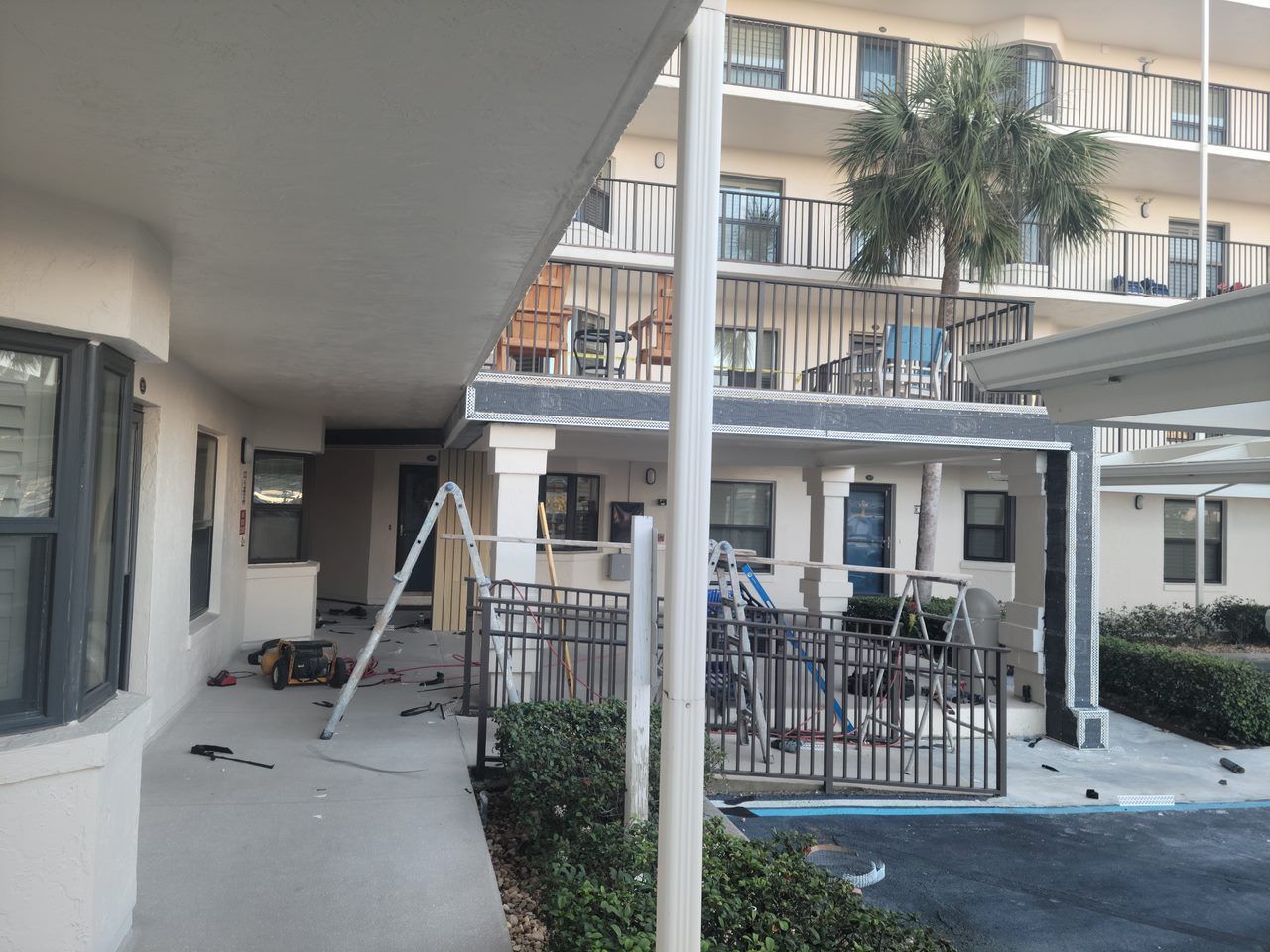 A building with a balcony and a ladder in front of it